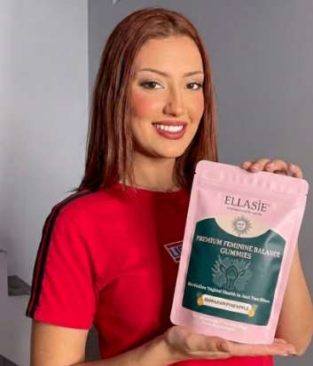 ginger woman holding ellasie feminine gummies pack