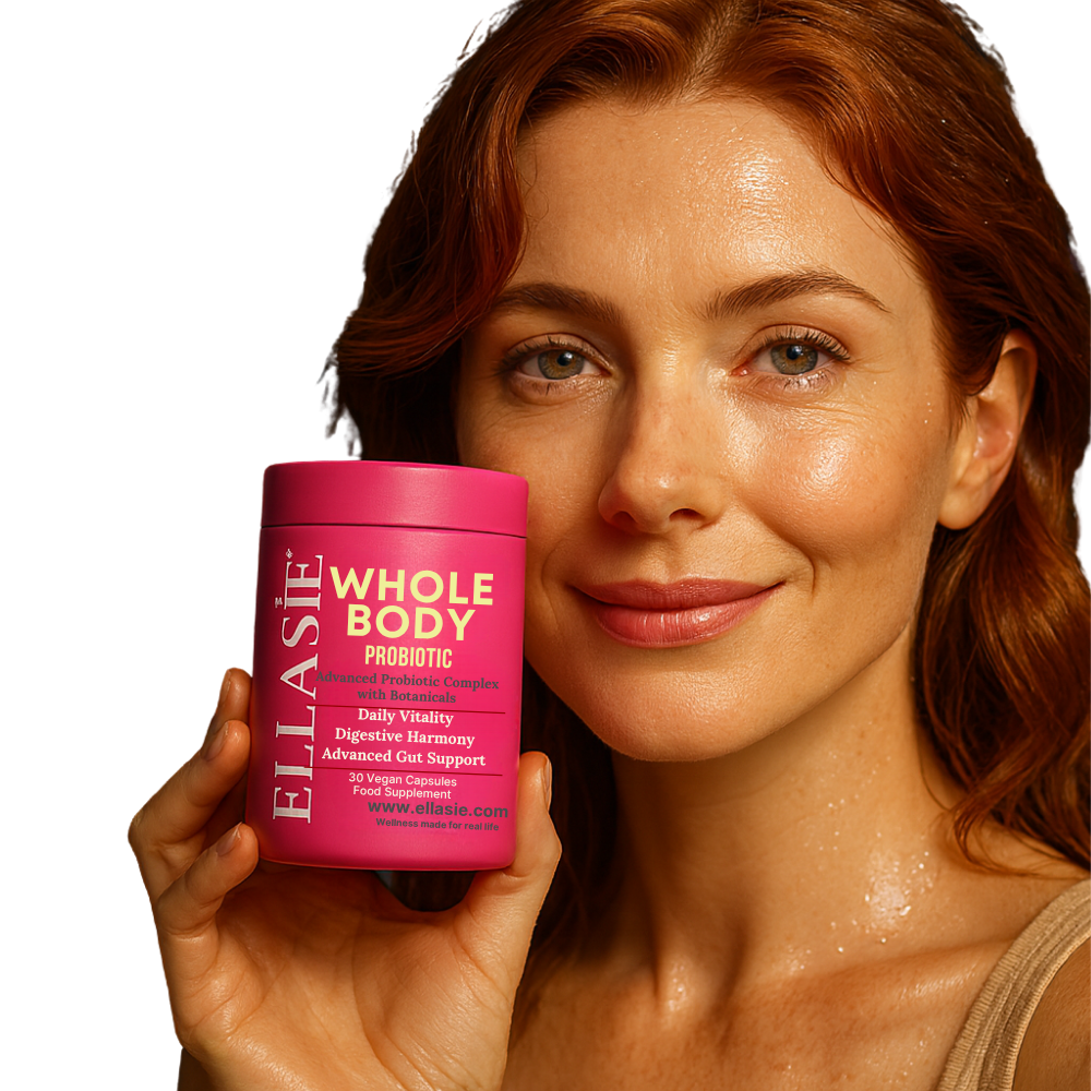 Woman holding a pink supplement container labeled 'Whole Body Probiotic' by ELASIE against a white background
