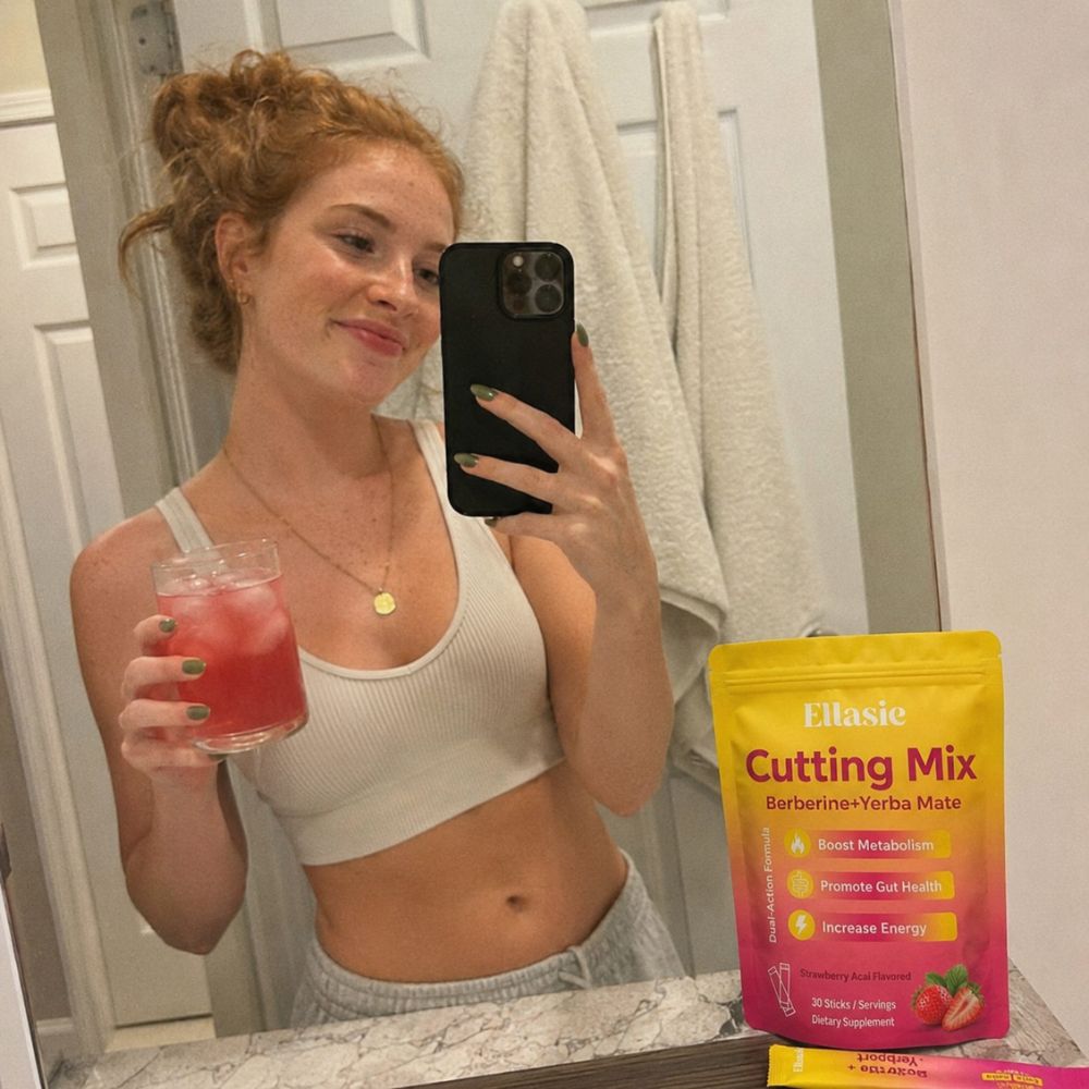 young woman in a selfie with cutting drink mix and a glass ith ice and juice