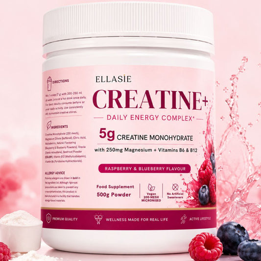 A white tub of Ellasie Creatine+ Daily Energy Complex powder with raspberry and blueberry flavor, shown on a pink background with fresh berries and a splash of liquid.