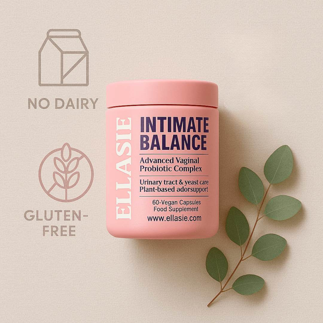 Pink container of Ellasie Intimate Balance Probiotic Complex on a beige background with green leaves.