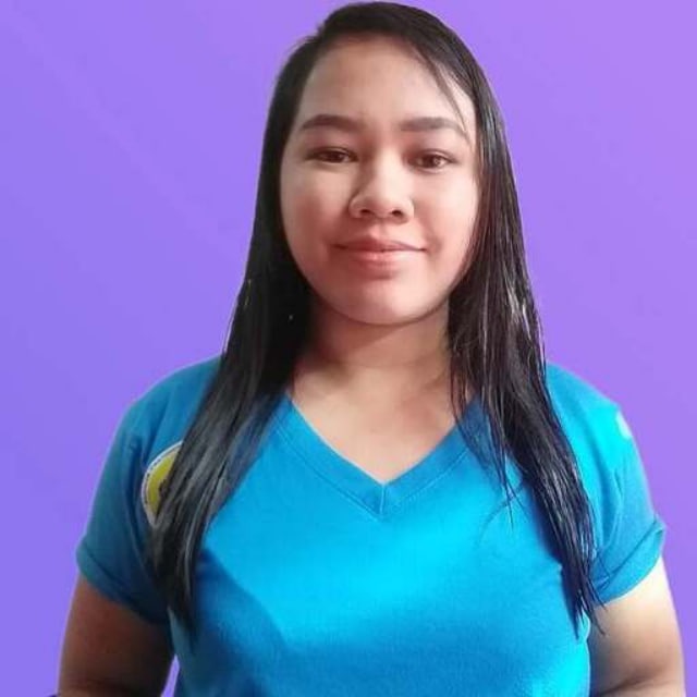 Person wearing a blue shirt against a purple background