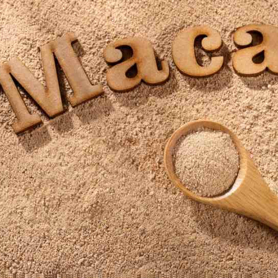 maca root powder with a wooden spoon